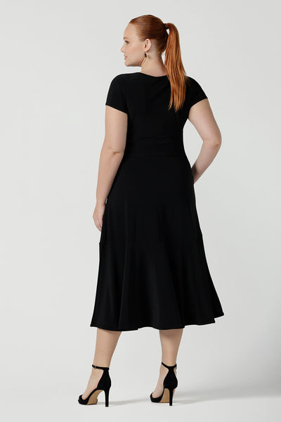 Back view of a dress in black is a slim fit round neck dress with waist seam and tier at the bottom. Functioning pockets. Great for work or event occasions. Made in Australia. Size inclusive fashion for women size 8 - 24.