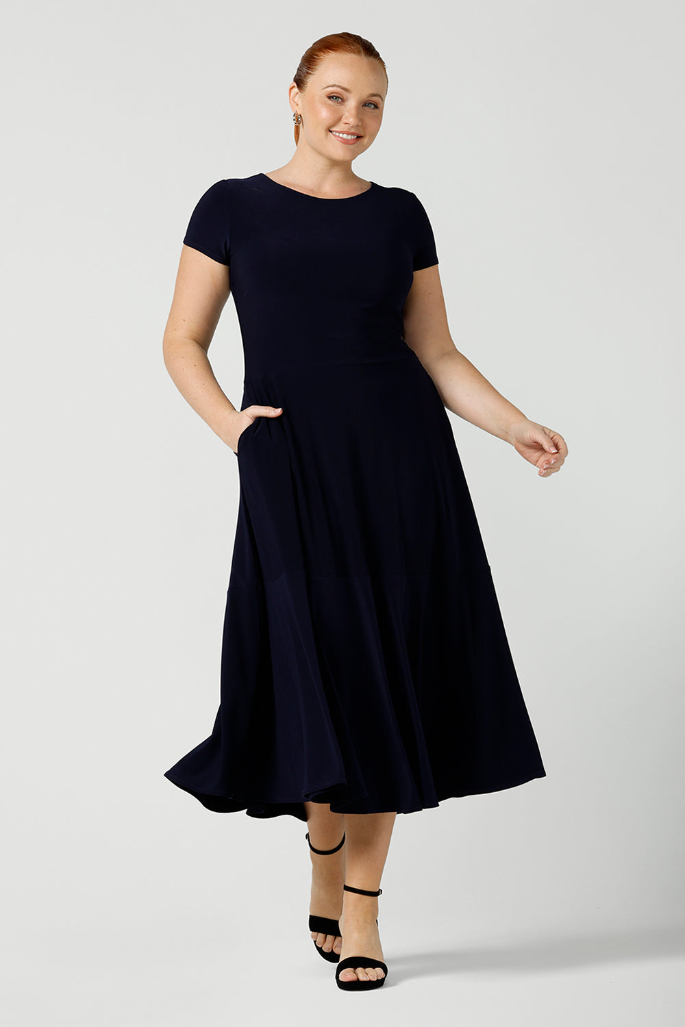 If you're looking for dresses made in Australia, look to this elegant navy dress. This high neck, short sleeve dress with flared skirt and ruffle hemline is a good workwear dress as well as a classic cocktail dress. With a midi-length skirt, shop this dress in plus sizes as well as petite thanks to Australian made, ethical ladies clothing brand, Leina & Fleur.