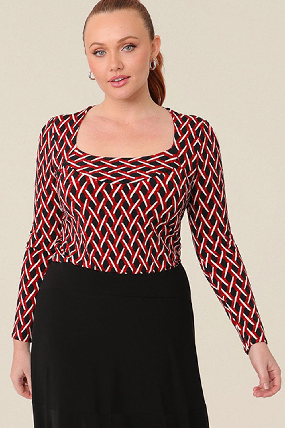 A good top for curvy women, the Amari Top in Chevron has a structured square neckline. A long sleeve top with a dipped hemline to the back, this printed jersey workwear top is available to shop online in plus sizes.