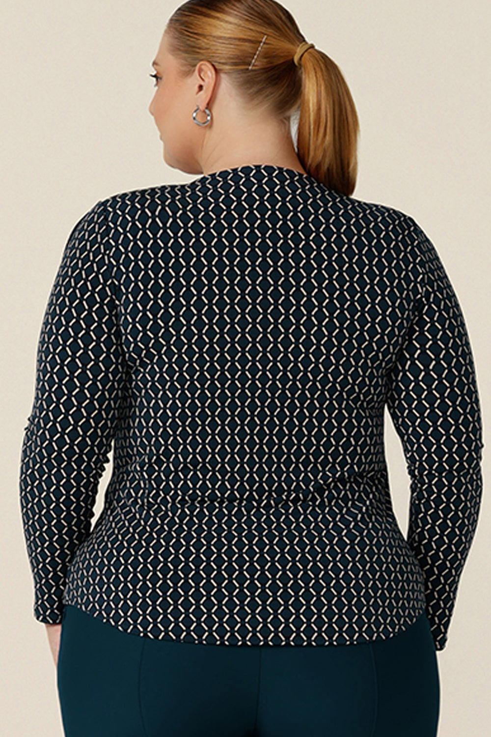Back view of a plus size, size 18 woman wearing a long sleeve tops with squared scoop neckline. In geometric print jersey, this comfortable top is good for work wear capsule wardrobes. Made in Australia, shop tops in sizes 8 to 24.