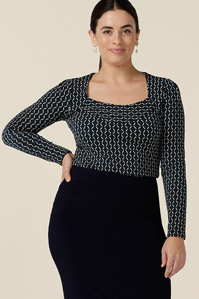 A good work top for corporate capsule wardrobes, this long sleeve top has a squared scoop neckline and blue and white geometric print. Made in Australia, this office wear top is readyt o shop in sizes 8 to 24. 