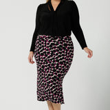 Andi Midi Skirt in Alula in a size 18 is a midi length skirt with the Alula print. Made in Australia style. Styled back with the Thom Top in black. - 24.