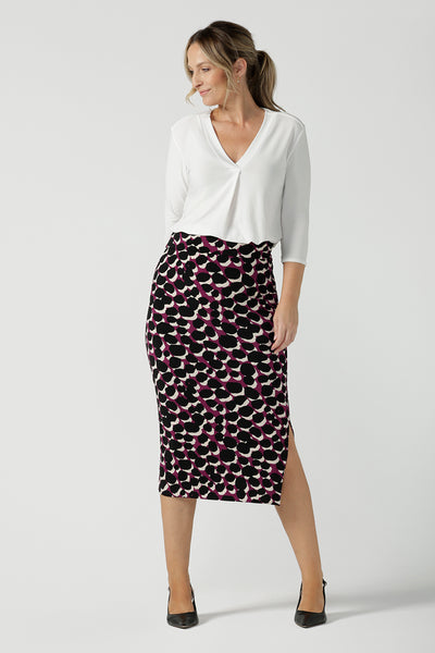 A size 10 woman wears the Alula Midi skirt in a size 10 back with a Jaime top in white bamboo. Made in Australia for women size 8 -24. 