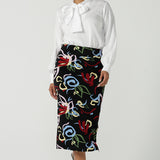  A size 10 woman wears the Boronia Midi Skirt back with a white Tencel Matisse shirt with a tick neckline. Made in Australia for women size 8 - 24.