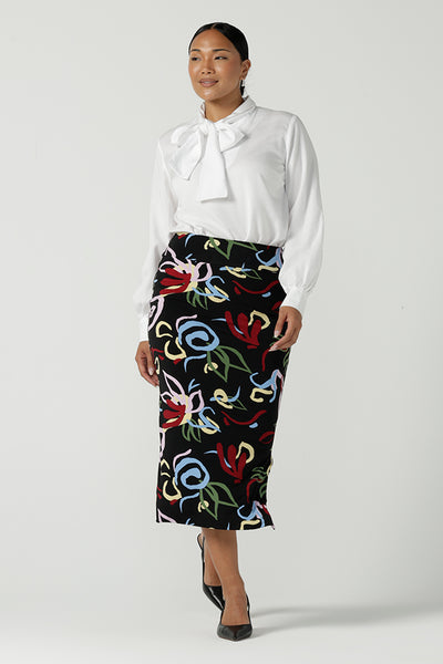  A size 10 woman wears the Boronia Midi Skirt back with a white Tencel Matisse shirt with a tick neckline. Made in Australia for women size 8 - 24.