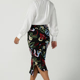 A size 10 woman wears the Boronia Midi Skirt back with a white Tencel Matisse shirt with a tick neckline. Made in Australia for women size 8 - 24.