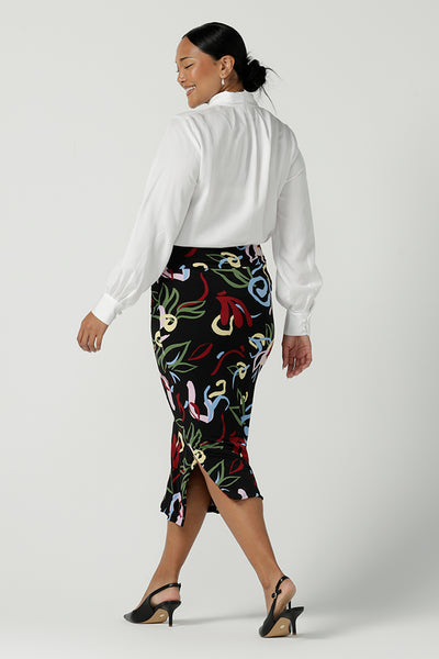 A size 10 woman wears the Boronia Midi Skirt back with a white Tencel Matisse shirt with a tick neckline. Made in Australia for women size 8 - 24.