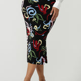 Close up of a size 10 woman wears the Boronia Midi Skirt back with a white Tencel Matisse shirt with a tick neckline. Made in Australia for women size 8 - 24.