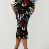 Back view of a size 10 woman wearing the Boronia Midi Skirt back with a white Tencel Matisse shirt with a tick neckline. Made in Australia for women size 8 - 24.