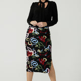 Size 10 woman wears the Boronia Midi Skirt back with a black tie neck top. Made in Australia for women size 8 - 24. 