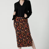 A size 10 woman is wearing the Andi Midi Tube skirt in Lava. A leopard print jersey print work skirt. Made in Australia for women size 8 - 24. 