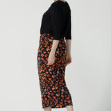 Back view of a size 10 woman is wearing the Andi Midi Tube skirt in Lava. A leopard print jersey print work skirt. Made in Australia for women size 8 - 24.