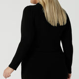 Back view of a size 18 woman wears the Thom top in Black a tie neck top with a V-neckline. Made in comfortable jersey have and made in Australia for women size 8 - 24.