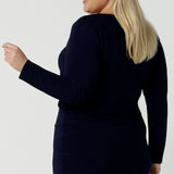 Back view of a Size 18 woman wears the Navy Mason top in Navy dry touch jersey. Made in Australia for women size 8 -24. Long sleeve and round neckline. Styled back with the Andi skirt in navy.