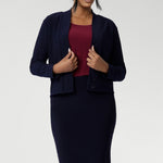 Crafted from a navy dry-touch jersey fabric with a soft stretch, this skirt offers both comfort and style. The double-layer design ensures a flattering fit, while the soft folded waistband adds extra comfort. Featuring a convenient pull-on style, the Andi Tube Skirt is available in a mini length for a bold and stylish look.