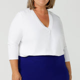 A good white top for your capsule wardrobe, this V-neck , 3/4 sleeve top is made in luxurious white bamboo jersey.  Shown on a size 18, plus size woman,  this classic top makes a great work blouse. Made in Australia by Australian andNew Zealand women's clothing brand, Leina & Fleur, this white jersey top is available to shop online in sizes 8 to 24.