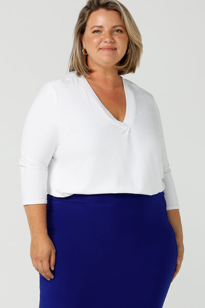 A good white top for your capsule wardrobe, this V-neck , 3/4 sleeve top is made in luxurious white bamboo jersey.  Shown on a size 18, plus size woman,  this classic top makes a great work blouse. Made in Australia by Australian andNew Zealand women's clothing brand, Leina & Fleur, this white jersey top is available to shop online in sizes 8 to 24.
