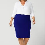 A good white top for your capsule wardrobe, this V-neck , 3/4 sleeve top is made in luxurious white bamboo jersey. Worn with a cobalt blue tube skirt and shown on a size 18, plus size woman, this classic top makes a great work blouse. Made in Australia by Australian andNew Zealand women's clothing brand, Leina & Fleur, this white jersey top is available to shop online in sizes 8 to 24.