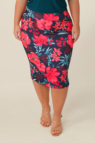 A curvy size 16 woman wears good work wear for plus size women, a knee-length tube skirt in floral print. Made in Australia, shop this work skirt online in sizes 8 to 24.