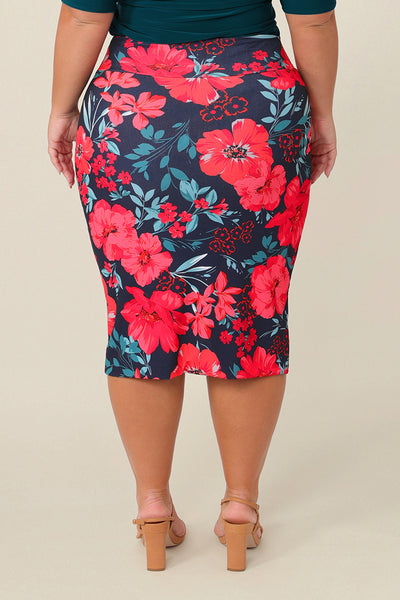 Back view of a A curvy size 16 woman wears good work wear for plus size women, a knee-length tube skirt in floral print. Made in Australia, shop this work skirt online in sizes 8 to 24.