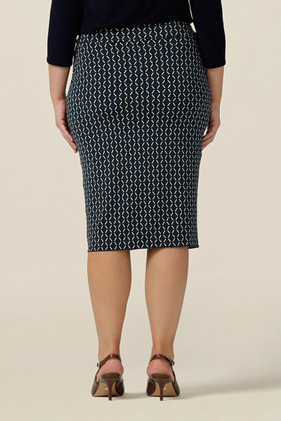 Back view of a good work wear skirt for corporate women. This knee-length tube skirt in geometric print is worn with a long sleeve black top. Made in Australia, shop this work skirt online in sizes 8 to 24.