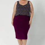 Plus size woman wears magenta coloured tube skirt, paired with summer cami and brown kitten heel. Stretchy tube skirt is made from lux dry touch jersey fabric and provides full body stretch. Available in sizes 8-24.