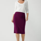 A size 10 woman wears the Andi skirt in Magenta. A made in Australia skirt styled back with the Jules top in white. Size 8 - 24. 