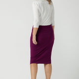 Back view of a size 10 woman wears the Andi skirt in Magenta. A made in Australia skirt styled back with the Jules top in white. Size 8 - 24.