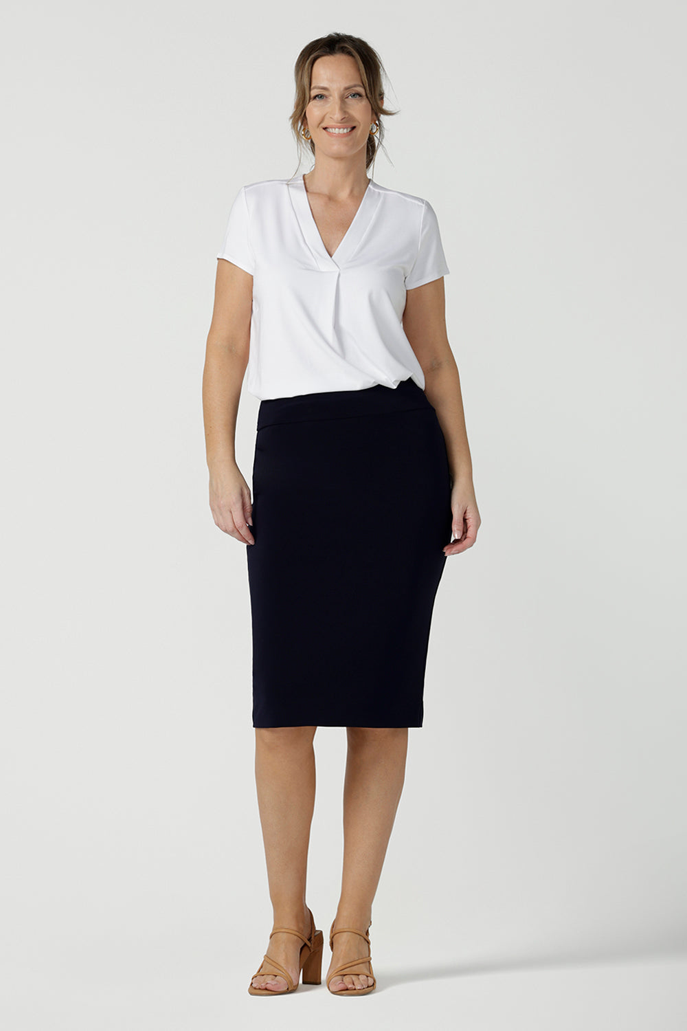 A good navy skirt for women's workwear, this stretch jersey tube skirt moulds to the curves. Great as an office skirt, this navy knee length pull-on skirt is worn with a V-neck white bamboo jersey top with short sleeves.