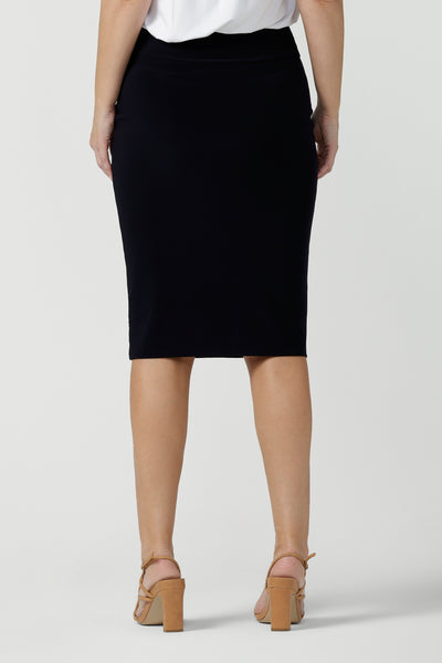 Back view of a good navy skirt for women's workwear, this stretch jersey tube skirt moulds to the curves. Great as an office skirt, this black knee length pull-on skirt is made in Australia by Australian and New Zealand fashion brand, Leina & Fleur. 