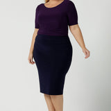 Size 18 woman wears the Andi skirt in Navy. A made in Australia work skirt for women. Styled back with Amethyst purple Ziggy Top. This skirt is easy care for work and made in comfortable jersey.   