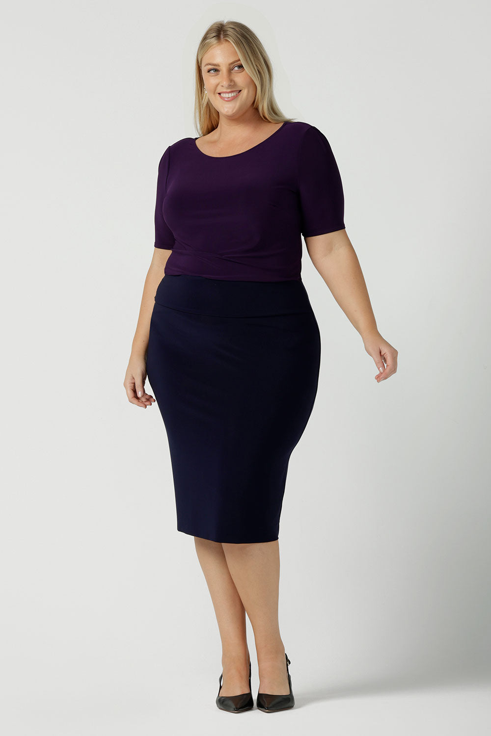 Size 18 woman wears the Andi skirt in Navy. A made in Australia work skirt for women. Styled back with Amethyst purple Ziggy Top. This skirt is easy care for work and made in comfortable jersey.   