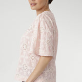  Exquisite botanical motifs and cut-out accents add artisanal charm to this breathable, easy-to-wear style. Pair with linen pants or the coordinating skirt for effortless summer elegance. 