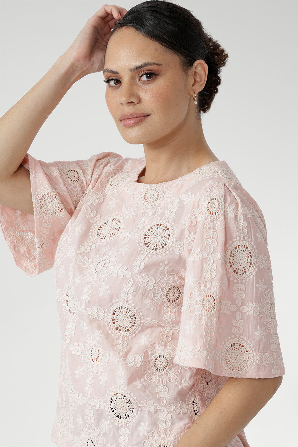 Australian designed top in a relaxed silhouette with a round neckline, topstitch detailing, and flared short sleeves finished with a subtle pleat.