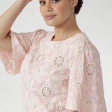 Australian designed top in a relaxed silhouette with a round neckline, topstitch detailing, and flared short sleeves finished with a subtle pleat.