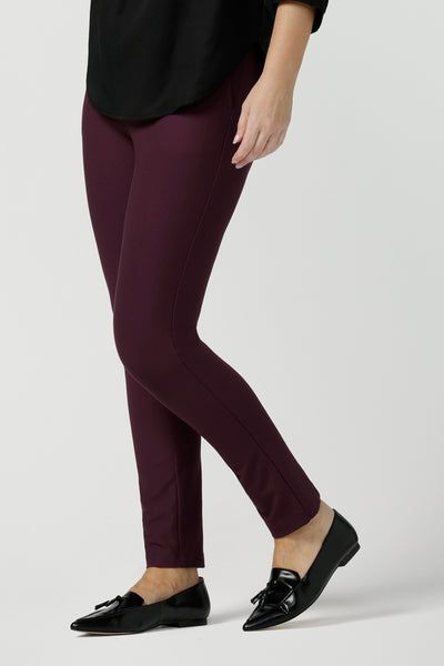 A size 10, forty plus woman wears slim leg, cropped length, stretch pants in Mulberry ponte jersey. Made in Australia by Australian and New Zealand women's clothing brand, L&F, these easy care pants work for corporate wear and weekend wear.