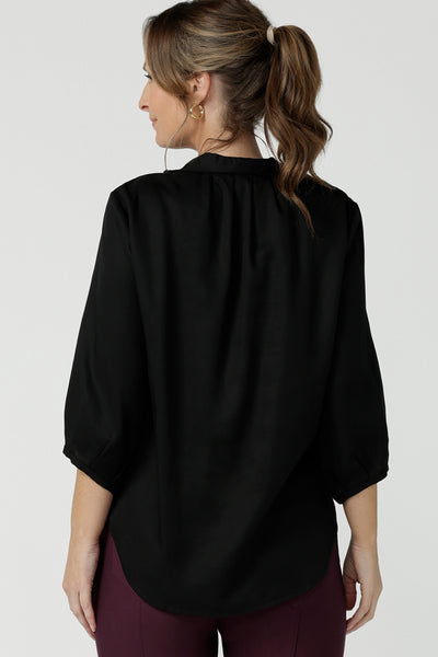Back view of a size 10  woman wearing a pull-on black shirt with 3/4. Made in Tencel fabric, the black shirt is lightweight, breathable and eco-conscious. Worn with mulberry pants, this shirt is great for casual wear as well as work. The shirt is Australian made for petite to plus size women.