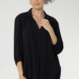 Over 30's woman wears a woven shirt with collar and tailored pleat front. Made from sustainable tencel fabric. Made in Australia for women size 8-24. 