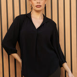 Plus size woman wears Graphite coloured woven shirt with collar and tailored pleat with wine work pants and black boots. Made from sustainable Tencel fabric in Australia for petite and plus size woman sizes 8-24. 