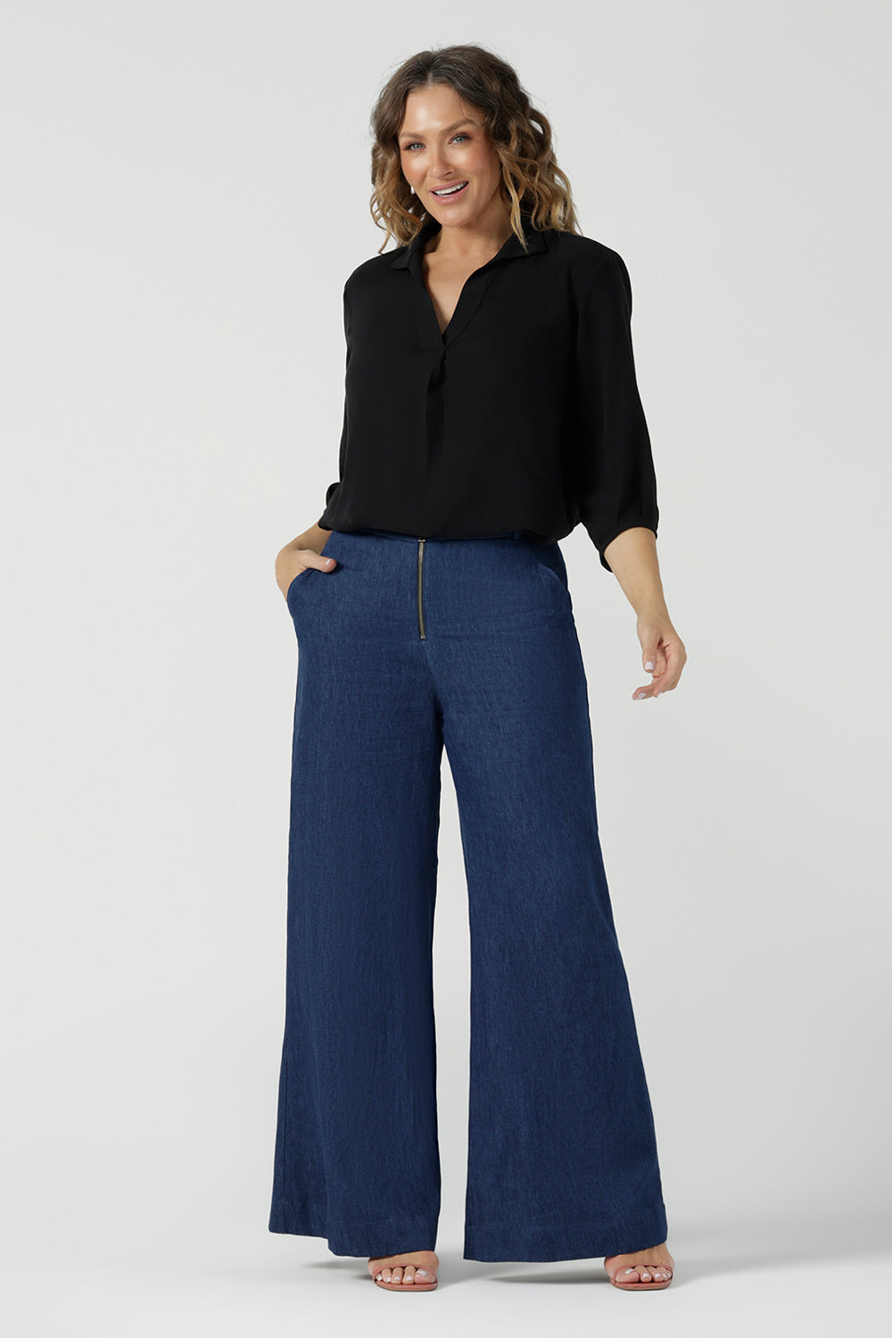A size 10 woman wears the Dutton Pant a denim pant with wide legs. Made in Australia for women size 8-24.