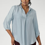 The Arley Shirt in Ice Blue offers a fresh take on everyday dressing with its clean, buttonless design and soft, suede-touch Tencel fabric. This pull-on style combines a sleek, contemporary silhouette with thoughtful detailing, making it a go-to piece for effortless polish. 