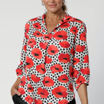 Made from eco-friendly Tencel twill, the fabric has a luxurious drape and smooth feel, with vibrant Povot design in white adorned with poppy details in red, tangerine, and black—adding a pop of colour while keeping the overall aesthetic refined. Though the fabric has no stretch, its beautiful drape creates a flattering, comfortable fit. Seen on over 40's model that wears her woven shirt with black linen pants in size 12. The Arley Shirt can be purchased in sizes 8-24.