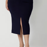 Close up shot of plus-sized model wearing navy work skirt. Midi length skirt pairs perfect with many different colours for corporate or office settings. Easy care fabric scube crepe jersey. This workwear skirt is Australian made by women in Australia and New Zealand. Leina & Fleur is a women’s retail brand that proudly stocks sizes from 8-24. Shop this navy 3/4 skirt in petite and plus sizes.