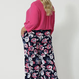 Back view of plus sized model wearing a breathable fabric pant made of dry touch jersey fabric. Floral pattern pant has many colours such as white, pink and navy. This comfortable work wear pant is great for both casual and dressy wear. These easy care pants are made in Australia by Australian and New Zealand women. Leina & Fleur is a woman’s fashion label that stocks sizes from 8 to 24. Shop this comfortable pant in plus size and petite sizes now.