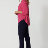 Side view of an over 40 year old woman wearing a shirt in a pink tencel fabric. This workwear shirt is for women on the go, made from Australian manufactured tencel fabric in the colour pink. Made in Australia by Australian and New Zealand women. Leina & Fleur is women's clothes brand with sizes that range from 8 to 24. Plus sizes and petite sizes are available.