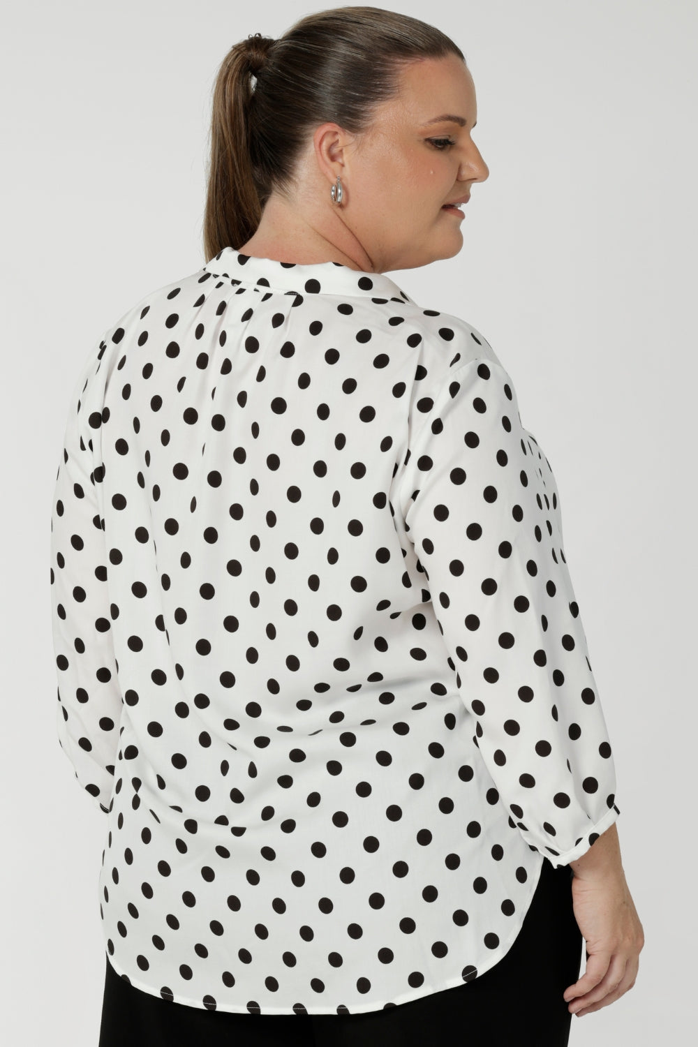 The playful black spots add a touch of personality and fun to the classic white blouse, keeping it modern and versatile for both work and casual outings. Easy care, easy wear design requires minimal fuss, so you can move through your day with ease, while its crisp, clean lines ensure you look polished and put together. Available in size 8-24.