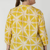 Back image of plus sized woman wearing yellow collard shirt. This pull-on style makes it easy to wear, while the semi-fitted silhouette creates a flattering shape without being too tight. Fabric has no stretch. Arley can be purchased in sizes 8-24.