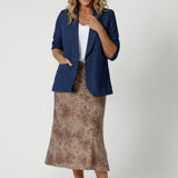 The combination of soft fabric and the charming print makes it a versatile piece that can be dressed up or down. The midi length falls just below the knee, offering an elegant balance between sophistication and casual ease. Size 12 model has paired skirt with denim blazer and brown sandal for a casual look.