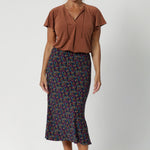 A sleek, sophisticated staple design for both work and travel. Size 12 woman wears clay coloured top with midi skirt and nude heel. Made from easy care dry touch jersey, that is wrinkle resistant. Available in sizes 8-24. 