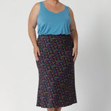 The midi length offers versatility, falling just below the knee to create a polished, refined appearance that's perfect for professional settings or travel. Size 18 woman pairs her Asher Skirt in Harmony with summer ready cami and nude shoe.